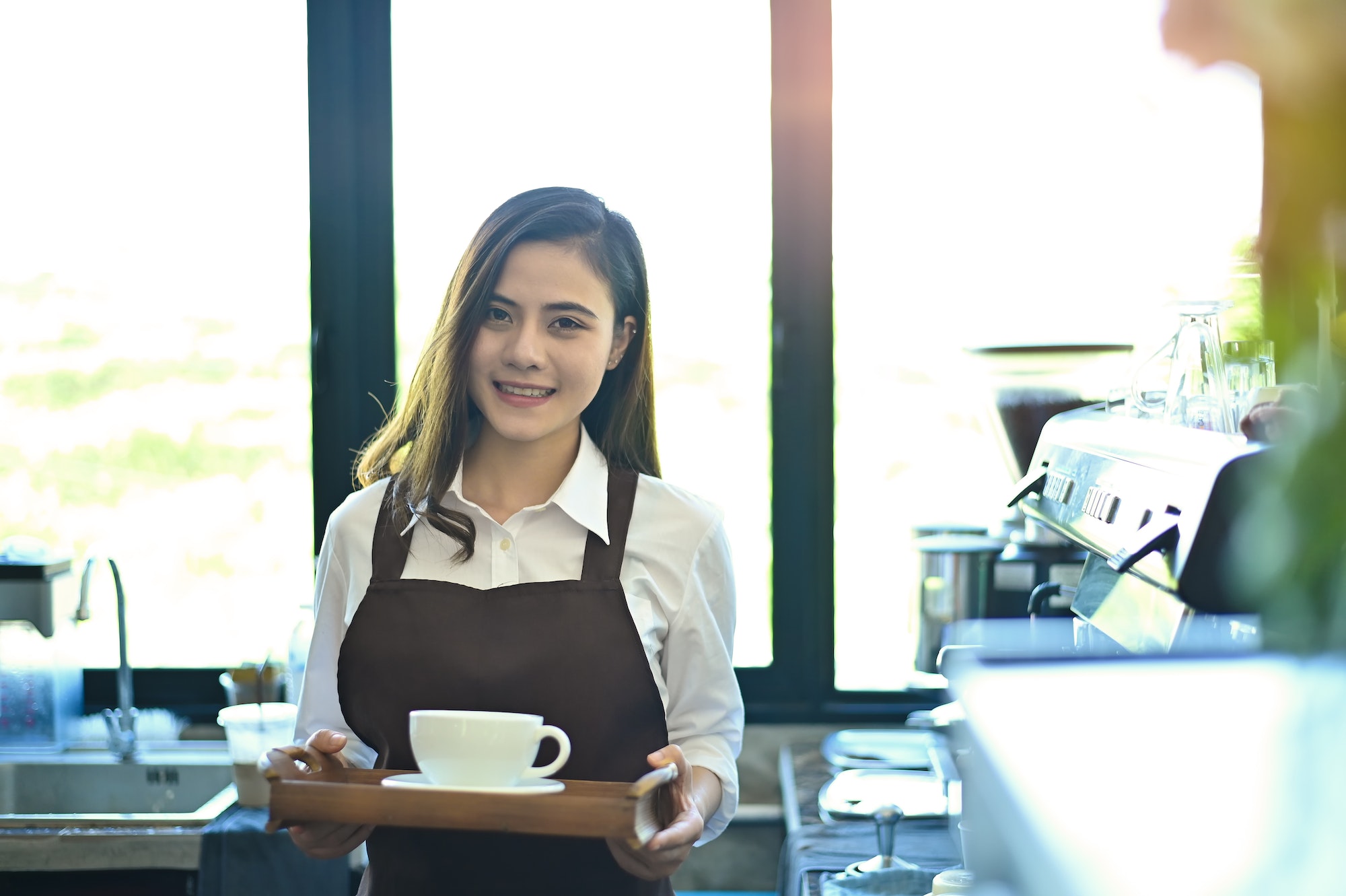 Asian woman working with barista coffee cafe.
